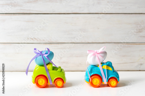 Two Easter cars with an egg and a car with the inscription 
