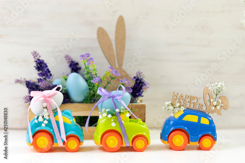 Two Easter cars with an egg and a car with the inscription 