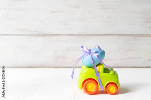 Easter cars with an egg on a white background, the concept of the approaching easter