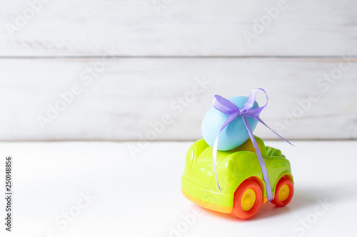 Easter cars with an egg on a white background, the concept of the approaching easter