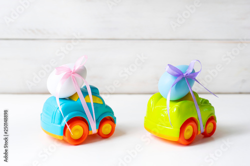 Two Easter cars with an egg and a car with the inscription 