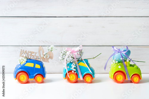 Two Easter cars with an egg and a car with the inscription 