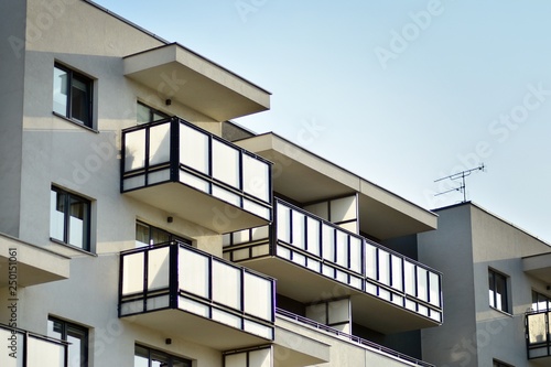 Modern white building with balcony on a blue sky