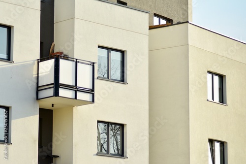 Modern white building with balcony on a blue sky