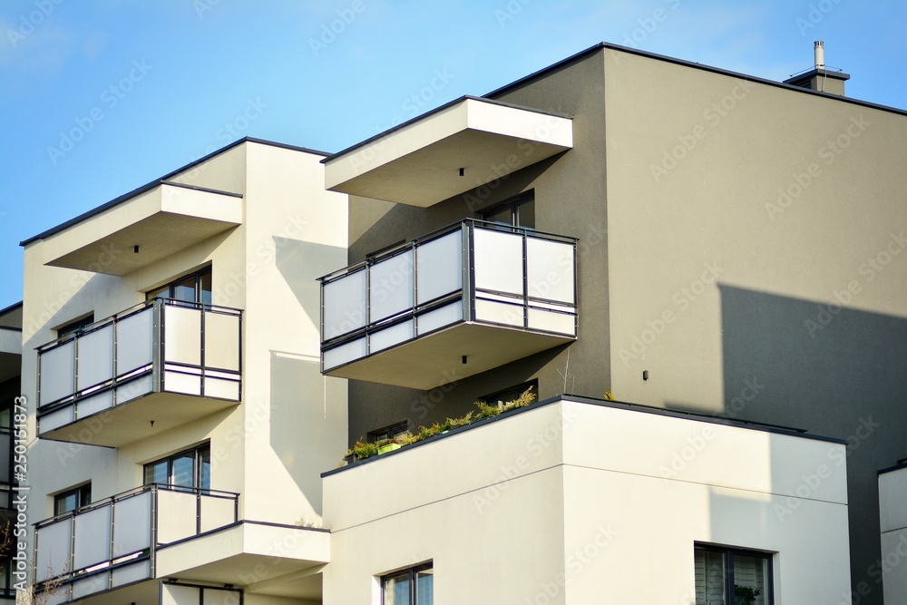 Modern white building with balcony on a blue sky