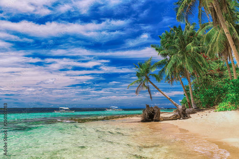 Beautiful beach. View of nice tropical beach with palms around. Holiday and vacation concept. Tropical beachat Philippines on the coast island Siargao