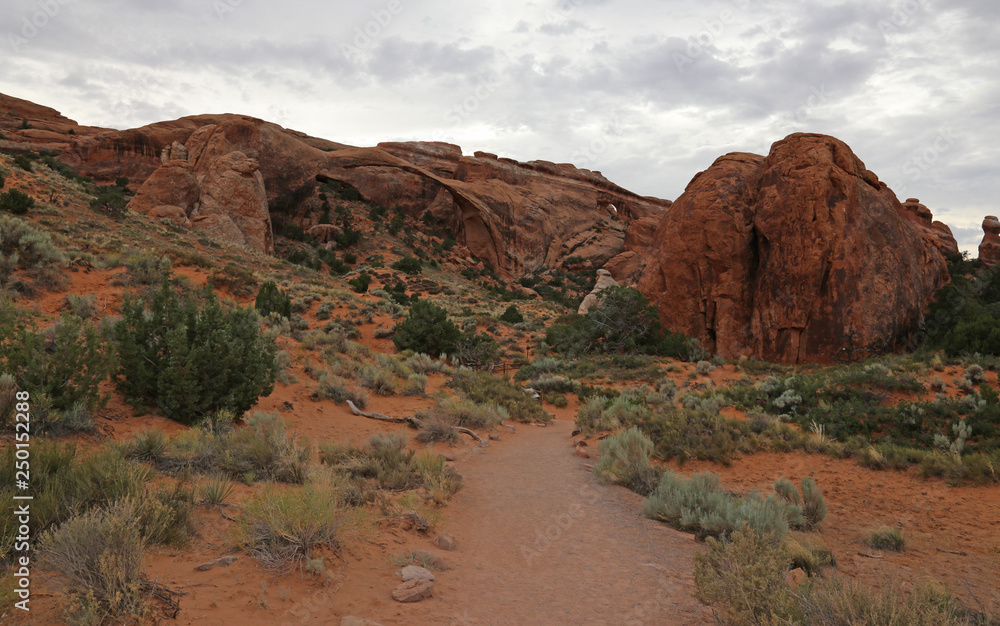 An overcast shot of the Landscape Arch in the distance in the Devils Garden in Arches National Park, Utah.