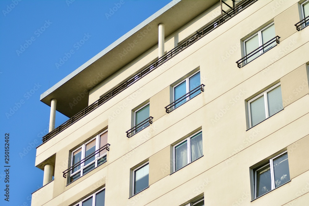 Modern white building with balcony on a blue sky