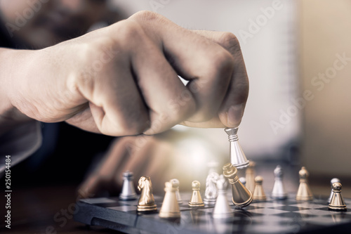 business man playing chess. He planing strategy for business.