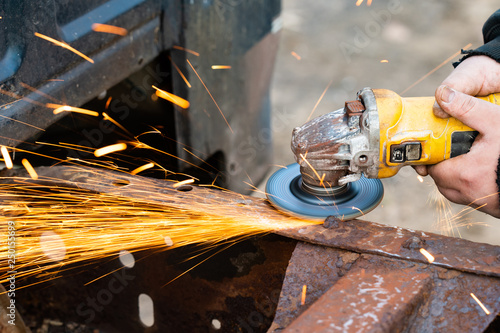 Mechanic Engineer Worker Grinding with Angle Grinder