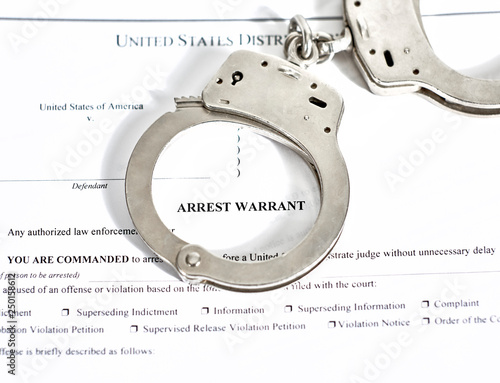 Arrest Warrant Court papers with Handcuffs