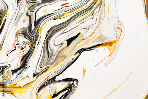 Mixture of acrylic paints. Modern artwork. Yellow and black mixed acrylic paints. Liquid marble texture. Applicable for design packaging, labels, business cards, and interactive web backgrounds.