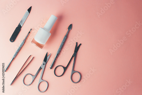 Manicure accessories on a pink background. Top view with copy space.
