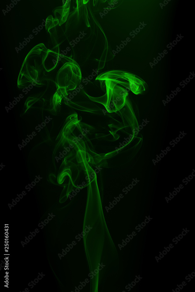 Fototapeta premium Movement of green smoke on black background for art design