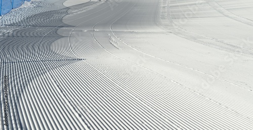 Trace of snow groomer on snow. Snow velvet. Ski and snowboard track. Prepared snow track. Cortina D'Ampezzo, Italy