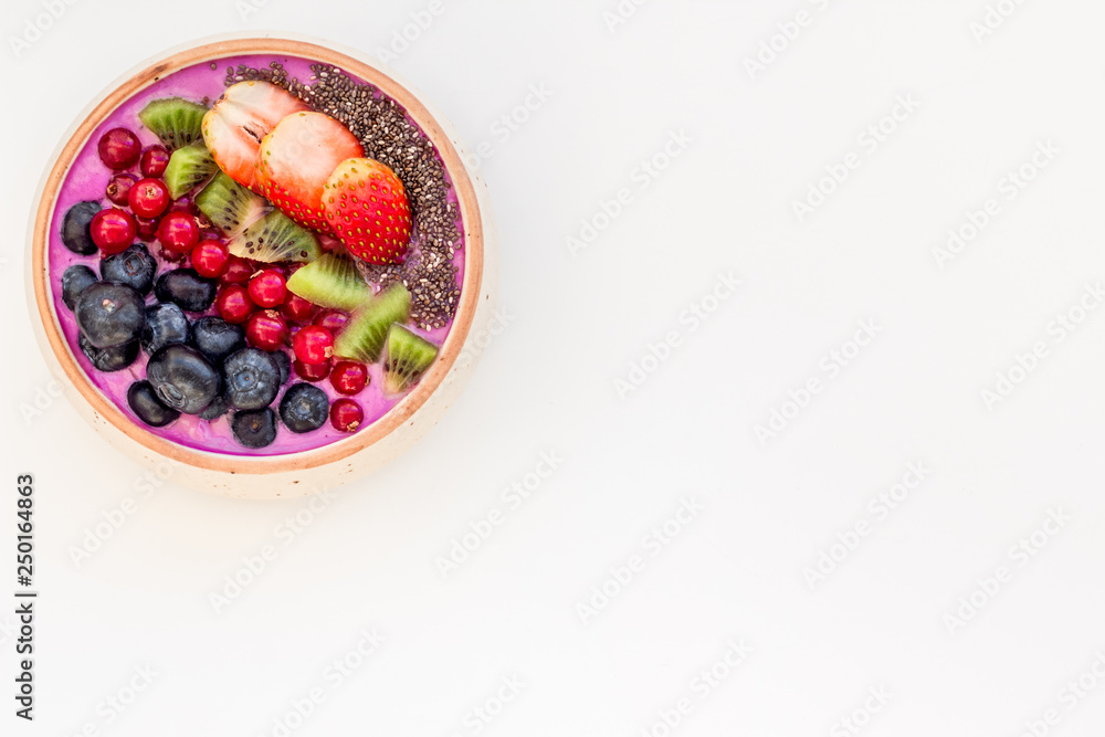 Superfoods. Acai smoothie bowl with fresh fruits, berries, chia seeds white background top view copy space Superfoods. Acai smoothie bowl with fresh fruits, berries, chia seeds white background top view copy space