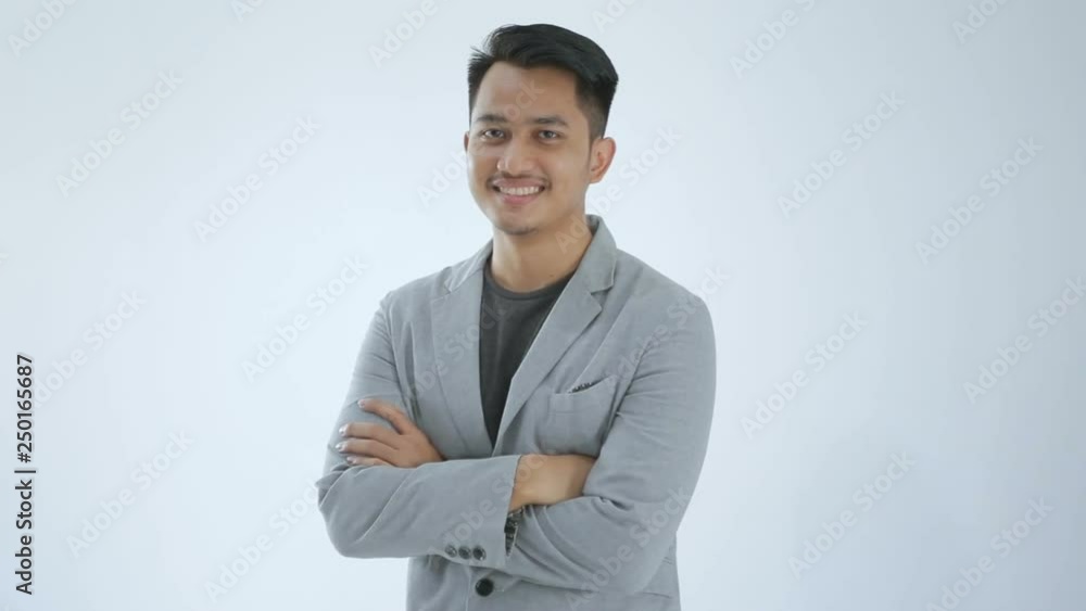 One business man smiling with arms folded through the camera One business man smiling with arms folded through the camera