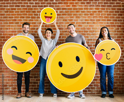 Diverse people holding positive emoticons photo