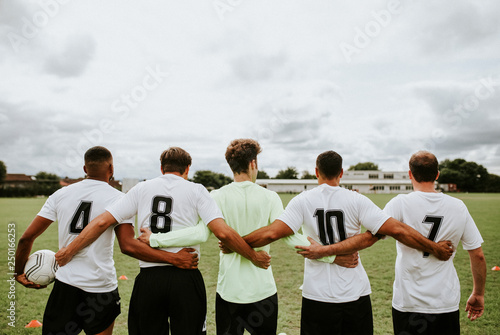 Football players standing together side by side photo