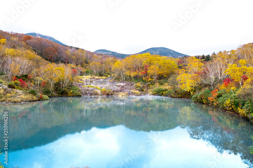 Jigokanuma pond view in panorama, soft blue pond with water reflection of trees shadows at Aomori Tohoku prefecture in autumn season,Japan