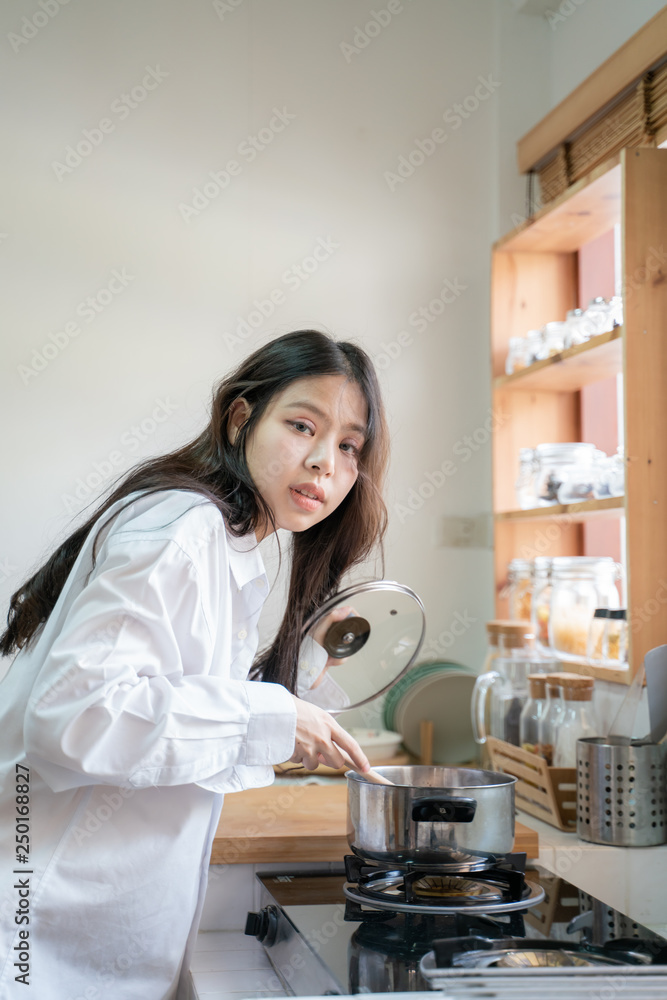 Asian women after wake up working in kitchen prepare breakfast meal Asian women after wake up working in kitchen prepare breakfast meal