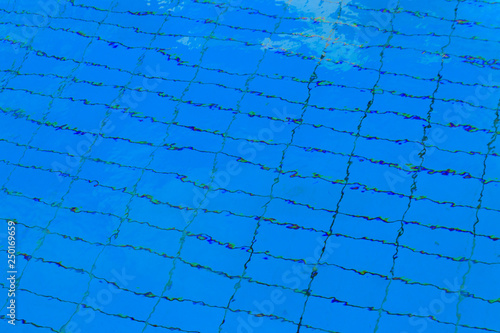 Texture of water in swimming pool for background. Surface of blue swimming pool