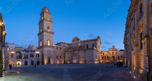 Panorama of Piazza del Duomo square , Campanile tower and Virgin Mary Cathedral ( Basilica di Santa Maria Assunta in Cielo ) , Caritas Diocesana in Lecce - Puglia, Italy. Baroque city of Apulia night