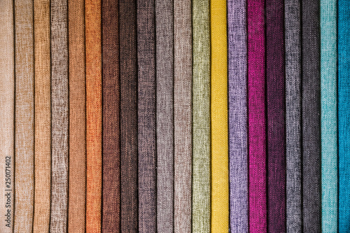 Colorful and bright fabric samples of furniture and clothing upholstery. Close-up of a palette of textile abstract stripes of different colors photo