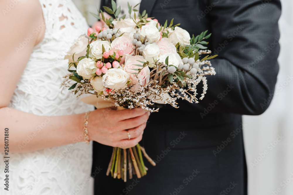 Wedding bouquet in the hands of bride Wedding bouquet in the hands of bride