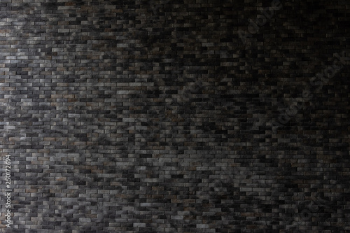Close up dark grey brick wall background.