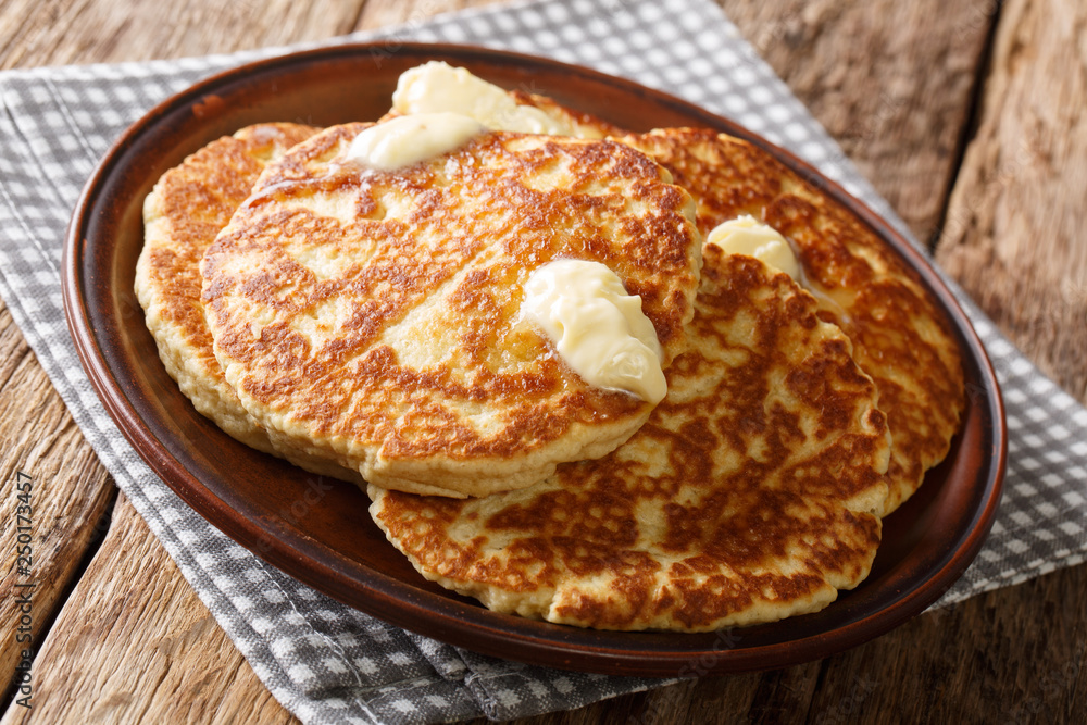 Homemade Gorditas de Azucar Sweet Griddle Cakes with butter close-up on a plate. horizontal Homemade Gorditas de Azucar Sweet Griddle Cakes with butter close-up on a plate. horizontal