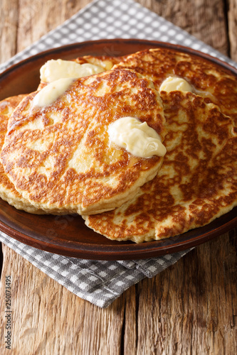 Delicious Sweet Griddle Cakes with butter close-up on a plate. vertical
