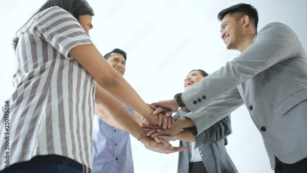 Stack hand a group of young asian business team together Stack hand a group of young asian business team together