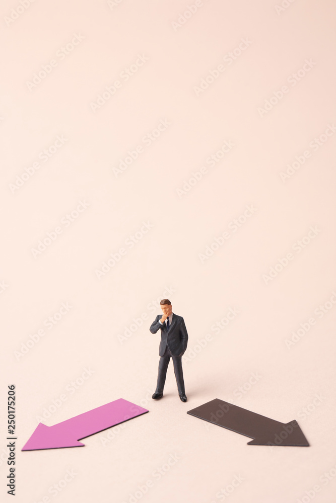 two direction arrows with miniature business man two direction arrows with miniature business man
