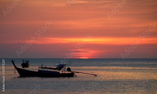 Silhouette of boat during sunset © munettt