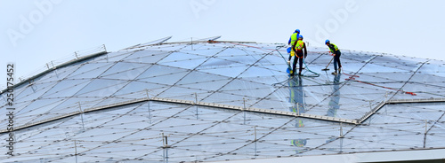 crew workers on the roof of a building
