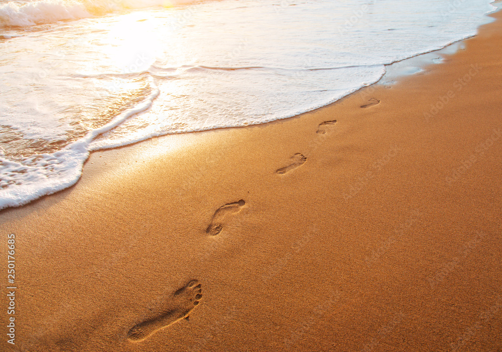 beach, wave and footprints at sunset time beach, wave and footprints at sunset time
