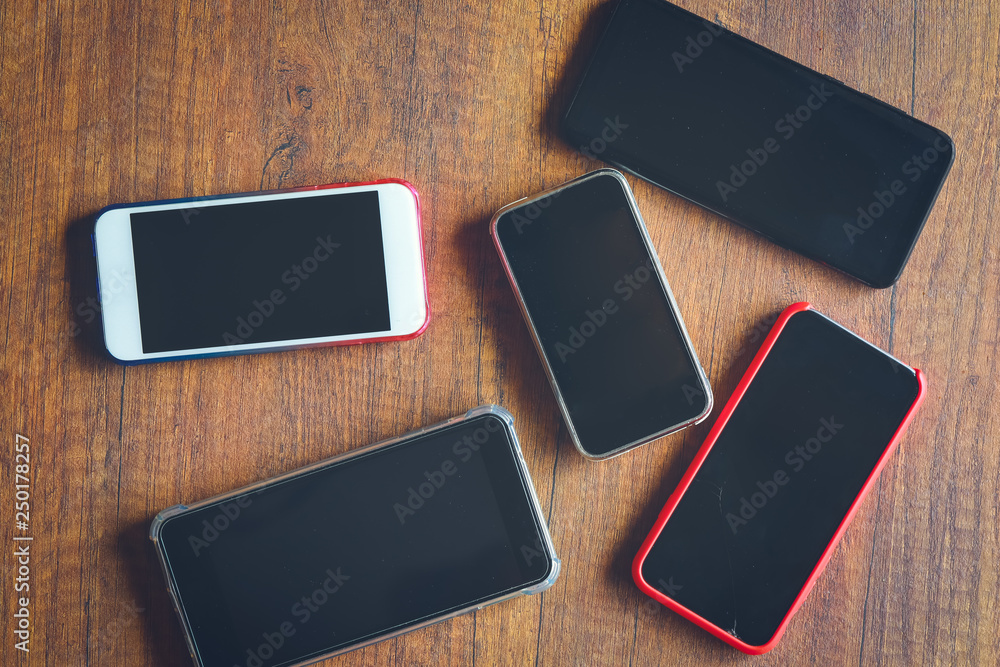 Many mobile phones on the wooden table Many mobile phones on the wooden table