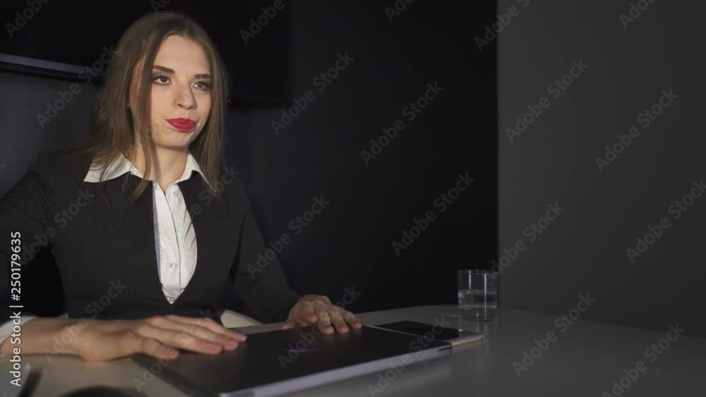 4К. Pretty business woman  close laptop in dark office. Steady shot
