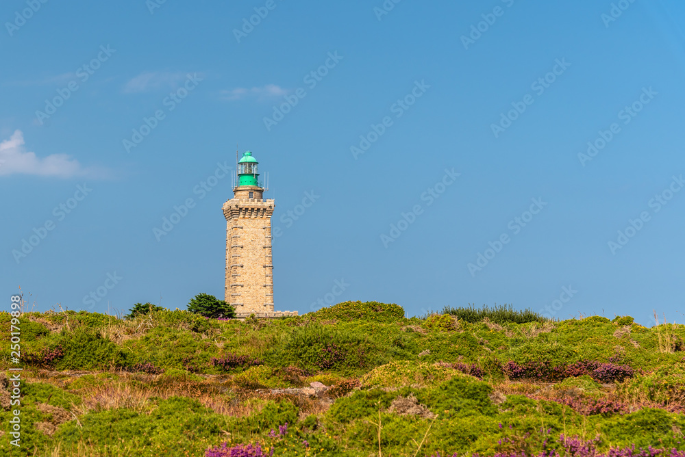 Lighthouse on Cap Frehel and violet fields against sky