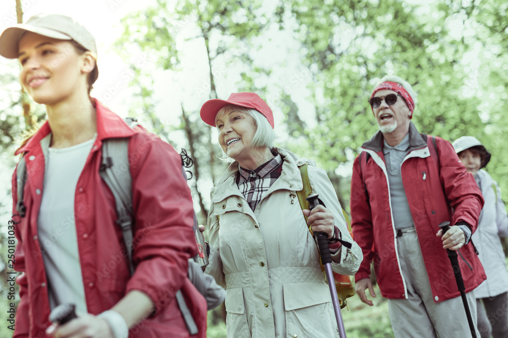 Elderly woman feeling inspired during hiking in forest