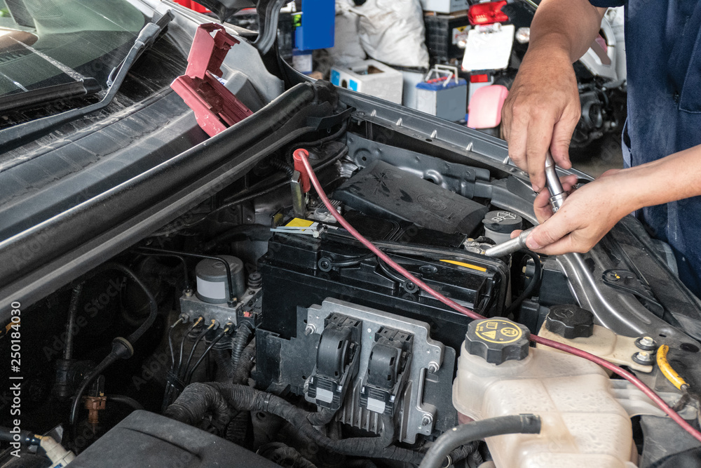 Auto mechanic repairing in a car Auto mechanic repairing in a car