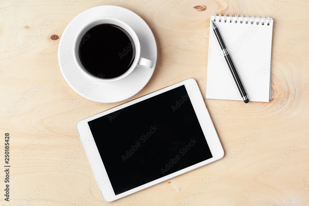 Digital tablet computer and cup of coffee on wooden desk. Digital tablet computer and cup of coffee on wooden desk.