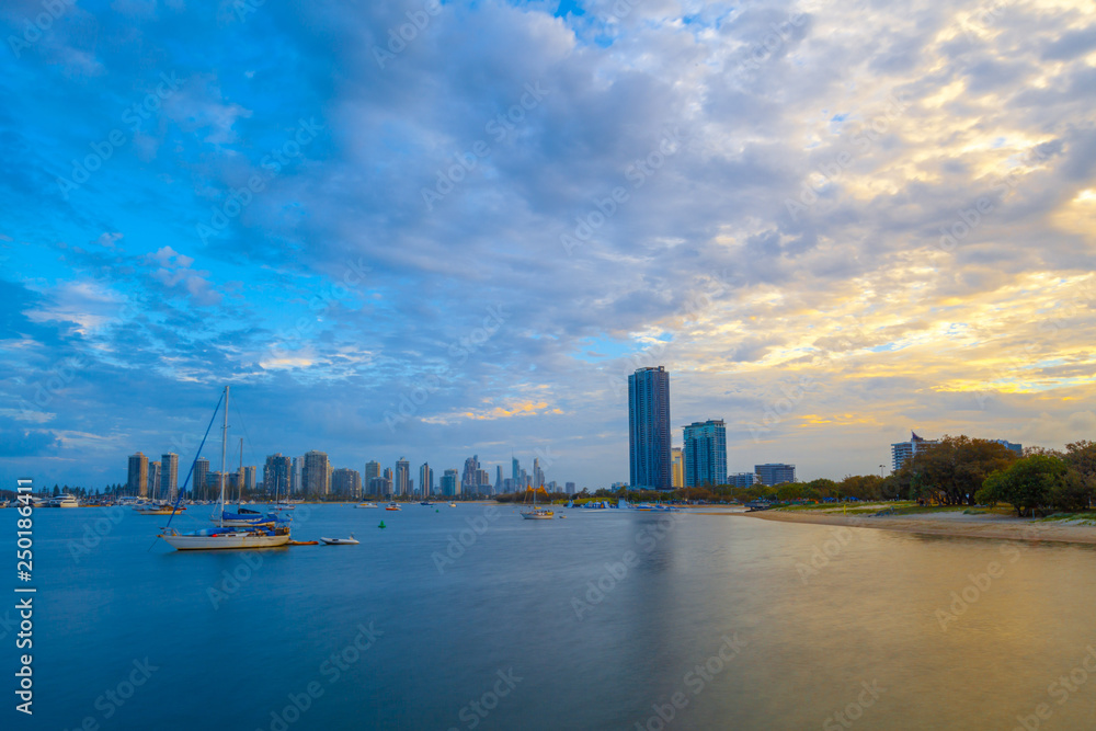 Moored sailboats and skyscrapers at sunset. Gold Coast, Queensland, Australia