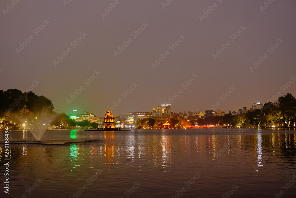 Night view of Turtle Tower or Tortoise tower which is located in the middle of the Hoan Kiem Lake, Hanoi, Vietnam
