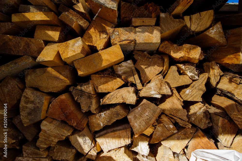 Wooden firewood stacked in a pile in firewood. Firewood in firewood Wooden firewood stacked in a pile in firewood. Firewood in firewood