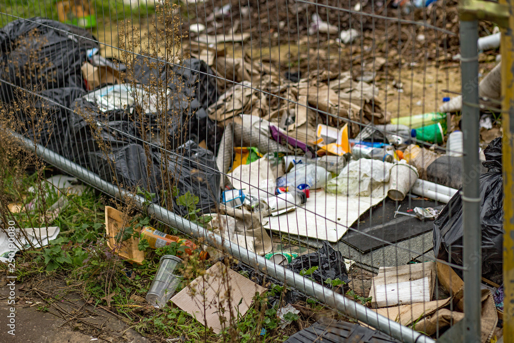 An urban area full of rubbish and waster illegally dumped