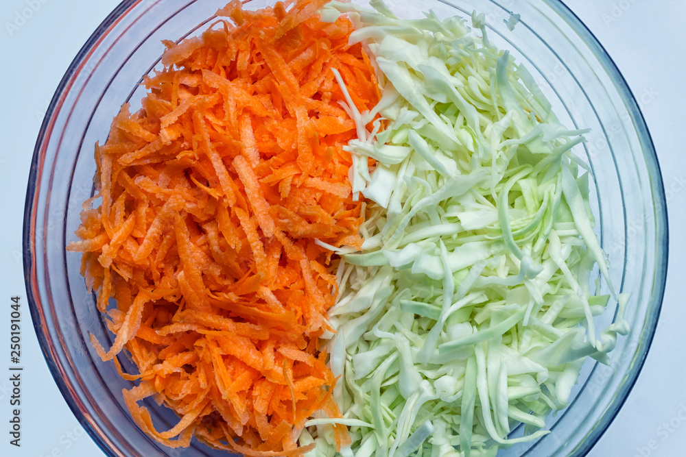Grated carrot and cabbage. Concept- vegetarianism, raw food, recipe. Grated carrot and cabbage. Concept- vegetarianism, raw food, recipe.