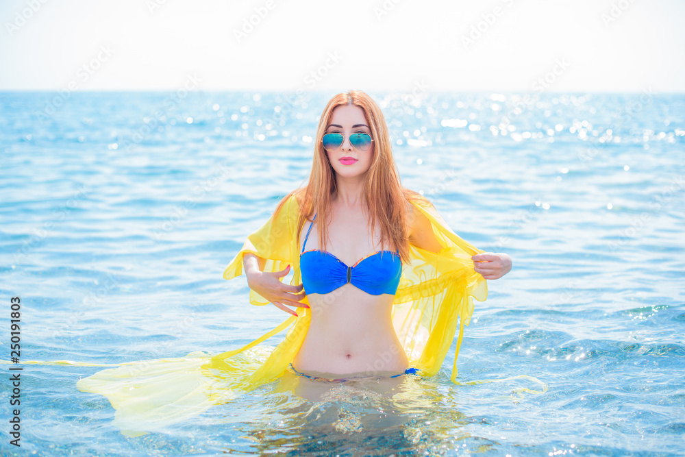 Vacation and summer concept. Redhead girl enjoy the sea and sun. Lady in swimwear at holidays Vacation and summer concept. Redhead girl enjoy the sea and sun. Lady in swimwear at holidays