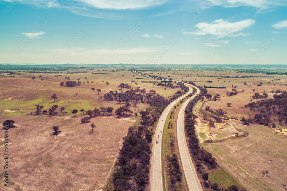 Aerial landscape of Hume Highway passing through agricultural land. Cullerin, New South Wales, Australia